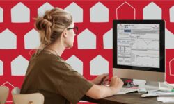Woman at computer looking at a data dashboard on a computer screen